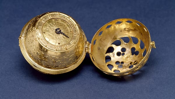 A printed carbon-copy receipt pad open on a counter beside a pen, a jeweller's loupe and a small tagged ring