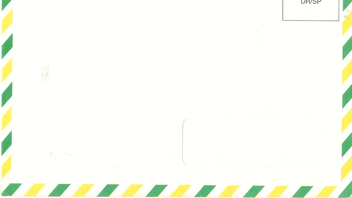 A person at a kitchen table with a multi-page printed letter, a yellow highlighter and a spiral notebook